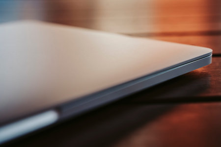 Laptop in an outdoor on a wooden table at sunset.の写真素材