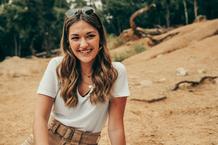 Pretty and young girl smiling in the middle of a forest.の写真素材
