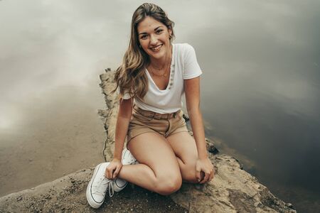 Pretty girl in the middle of a lake in a forest in summer, calm environment.の写真素材