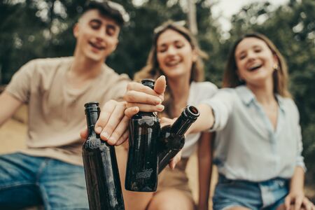 Young people drinking beer in nature in the middle of a forest.の写真素材