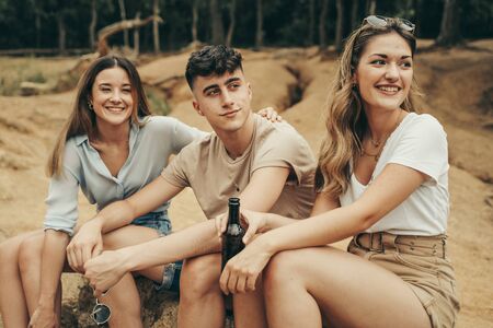 Friends observing the forest landscape in the middle of nature.の写真素材