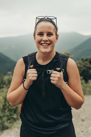 Hiker smiling on top of the mountain in nature.の写真素材