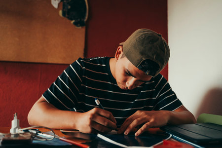 Young tattoo artist working in his professional studio in Barcelona, Spain.