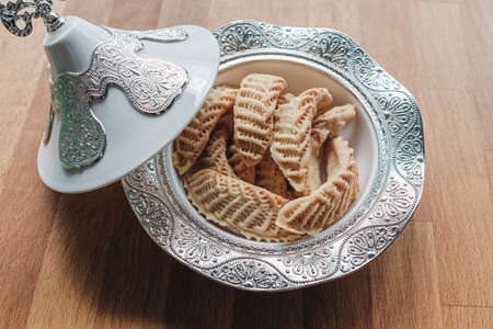 Homemade sweets from gazelle horns for Ramadan. Close-up detail shot of fresh baked Kaab El Ghazal, a moroccan sweet, Halal food.の写真素材
