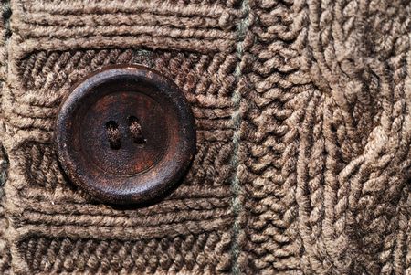 Button on a brown knitted cardigan.の写真素材