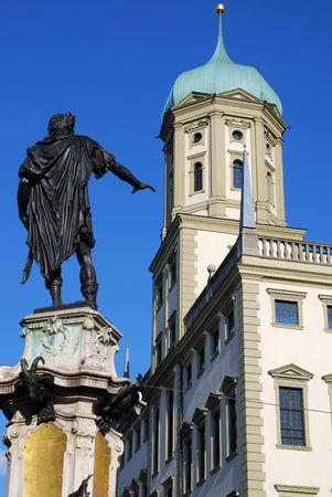 The city house of Augsburg (Bavaria, Germany) with a scuplture of the Augustus fountain in the foreground.の写真素材