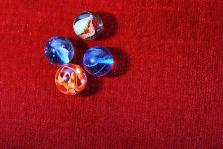 glass marbles on red velvetの写真素材
