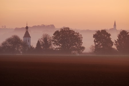 Autumn landscape with sunrise and fogの写真素材