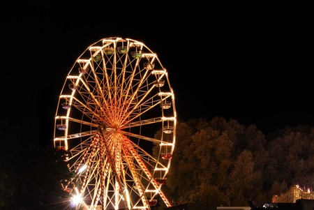 Ferris wheel at the fair ground at night.の写真素材