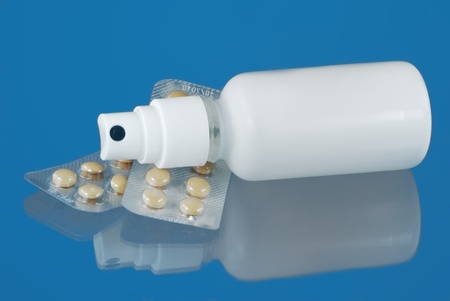 Blister pack of pills and a sprayの写真素材