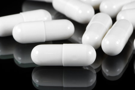 Lot of white medical capsules