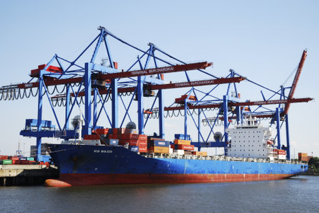 HAMBURG, GERMANY - AUGUST 20: Freighter at the docks at the Hamburg harbor on August 20, 2011. Foto taken from rund trip through the harbor by boat. Hamburg has the biggest port of Germany.のeditorial素材