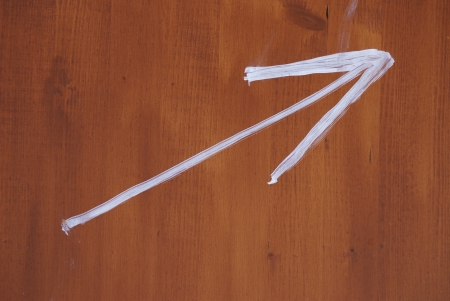 Painted arrow on a wooden boardの写真素材