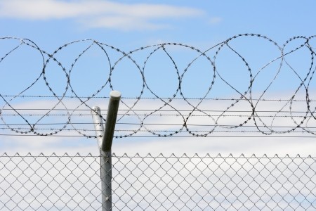 Security with a barbed wire fenceの写真素材