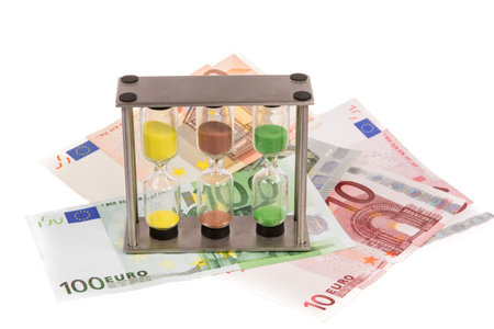 Sandglass and a couple of eure banknotes.