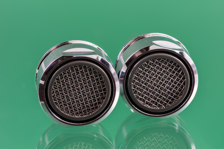Macro of two faucet aerators for reducing water consumption.の写真素材