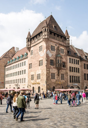 NUERNBERG, GERMANY - APRIL 6: Tourist at the Nassauer Haus in Nuernberg, Germany on April 6, 2014. The medieval resicence tower was built in the 13th century. Foto taken from Koenigstrasse.のeditorial素材