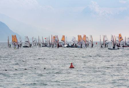 TORBOLE, ITALY - APRIL 22: Windsurfers on Lake Garda at Torbole on April 22, 2014. Lake Garda is the biggest lake of Italy, which is popular for windsurfing. Foto taken from Torbole water front.のeditorial素材