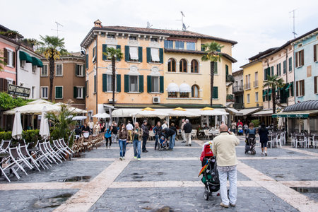SIRMIONE, ITALY - APRIL 23: Tourists at the Piazza Castello in Sirmione, Italy on April 23, 2014. The village is a very popular tourist destination at Lake Garda. Foto taken from Piazza Castelloのeditorial素材