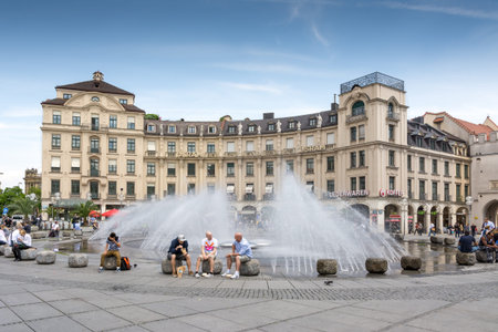 MUNICH, GERMANY - JUNE 4: Tourists at Stachus fountain in Munich, Germany on June 4, 2014. Munich is the biggest city of Bavaria  with almost 100 million visitors a year. Foto taken from Karlsplatz with view to Neuhauser Strasse.のeditorial素材