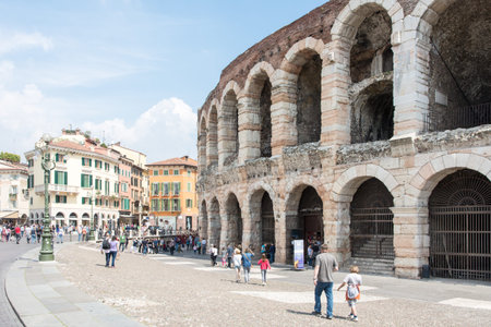 VERONA, ITALY - APRIL 23: Tourists at the arena of Verona, Italy - April 23, 2014. The amphitheatre could host more than 30,000 spectators in ancient times. Foto taken from Piazza Bra.のeditorial素材