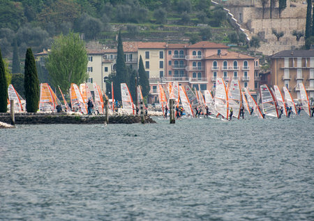 TORBOLE, ITALY - APRIL 22: Windsurfers on Lake Garda at Torbole on April 22, 2014. Lake Garda is the biggest lake of Italy, which is popular for windsurfing. Foto taken from Torbole water front.のeditorial素材