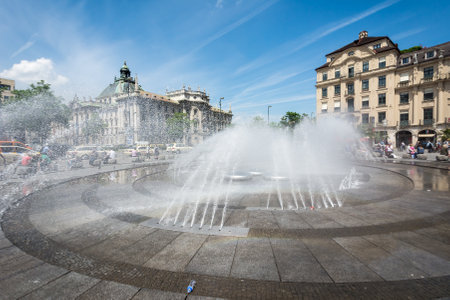 MUNICH, GERMANY - JUNE 4: Tourists at Stachus fountain in Munich, Germany on June 4, 2014. Munich is the biggest city of Bavaria  with almost 100 million visitors a year. Foto taken from Karlsplatz with view to Justizpalast.のeditorial素材