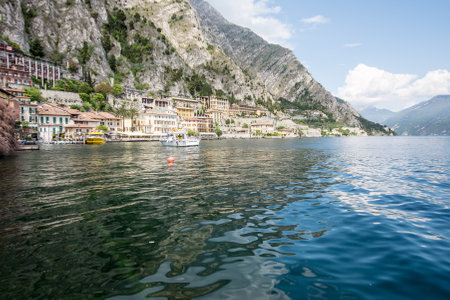 LIMONE, ITALY - APRIL 22: Motor yacht approaching the village of Limone, Italy on April 22, 2014. The town at Lake Garda is famous for the cultivation of lemons. Foto taken from the water front in Limone.のeditorial素材