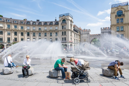 MUNICH, GERMANY - JUNE 4: Tourists at Stachus fountain in Munich, Germany on June 4, 2014. Munich is the biggest city of Bavaria  with almost 100 million visitors a year. Foto taken from Karlsplatz with view to Neuhauser Strasse.のeditorial素材