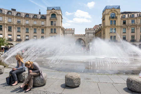 MUNICH, GERMANY - JUNE 4: Tourists at Stachus fountain in Munich, Germany on June 4, 2014. Munich is the biggest city of Bavaria  with almost 100 million visitors a year. Foto taken from Karlsplatz with view to Neuhauser Strasse.のeditorial素材