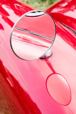 Vintage outside rear mirror of an old-timer.の写真素材
