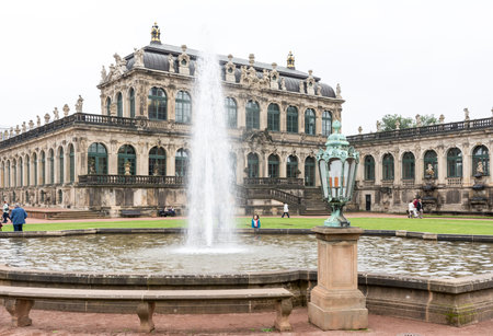 DRESDEN, GERMANY - SEPTEMBER 4: Tourists at the Zwinger palace in Dresden, Germany on September 4, 2014. By 1963 the Zwinger had largely been restored after it was completely destroyed 1945. Foto taken from the public Zwinger park.のeditorial素材