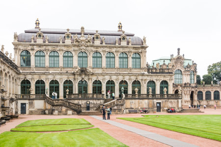 DRESDEN, GERMANY - SEPTEMBER 4: Tourists at the Zwinger palace in Dresden, Germany on September 4, 2014. By 1963 the Zwinger had largely been restored after it was completely destroyed 1945. Foto taken from the public Zwinger park.のeditorial素材