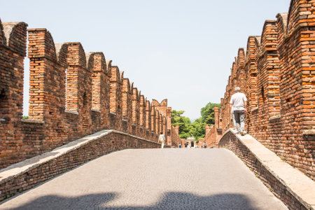VERONA, ITALY - JUNE 3: Tourists on Ponte Scaligero in  Verona, Italy on June 3, 2015. The bridge was built in the 14th century. Foto taken on Ponte Scaligero.のeditorial素材