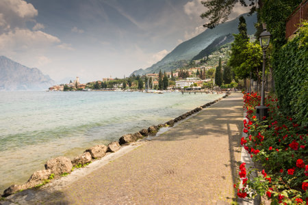 MALCESINE, ITALY - JUNE 1: Lake Garda water front at the village Malcesine, Italy on June 1, 2015. Lake Garda is one of the most frequented tourist regions of Italy. Foto taken from south of the town with view to the village.のeditorial素材