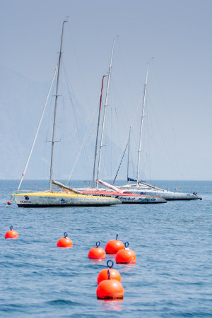 CASTELLETTO, ITALY - JUNE 2: Sailing boats at Lake Garda in Castelletto, Italy on June 2, 2015. Lake Garda is one of the most frequented tourist regions of Italy. Foto taken from Castelletto water front with view to the marina.のeditorial素材