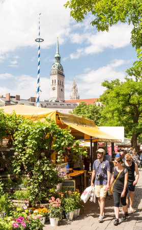 MUNICH, GERMANY - JULY 20: People at the Viktualienmarkt in Munich,  Germamy on July 20, 2015. This traditional market takes place every day since 1807 . Foto taken from Frauenstrasse with view to the Viktualienmarkt.のeditorial素材