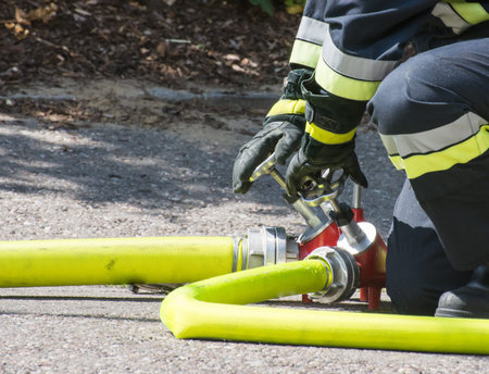 Fireman operating the valve of a firehose