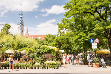 MUNICH, GERMANY - JULY 20: People at the Viktualienmarkt in Munich,  Germamy on July 20, 2015. This traditional market takes place every day since 1807 . Foto taken from Frauenstrasse with view to the Viktualienmarkt.のeditorial素材