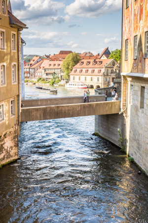 BAMBERG, GERMANY - SEPTEMBER 4: Tourists at the bridge to Altes Rathaus in Bamberg, Germany on September 4, 2015. The historic town hall was built in the 14th century. Foto taken from Obere Bruecke with view to Untere Bruecke.のeditorial素材