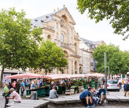 BAMBERG, GERMANY - SEPTEMBER 4: People at a street market in Bamberg, Germany on September 4, 2015. The historic city center of Bamberg is a listed UNESCO world heritage site. Foto taken from Gruener Markt with view to the St. Martin church.のeditorial素材