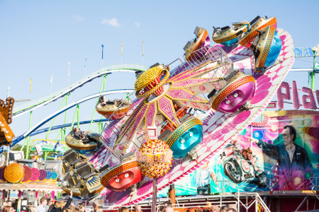 MUNICH, GERMANY - SEPTEMBER 30: Fairground rides at the Oktoberfest in Munich, Germany on September 30, 2015. The Oktoberfest is the biggest beer festival of the world with over 6 million visitors each year. Foto taken from Theresienwiese.のeditorial素材