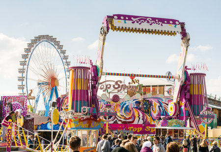 MUNICH, GERMANY - SEPTEMBER 30: Fairground rides at the Oktoberfest in Munich, Germany on September 30, 2015. The Oktoberfest is the biggest beer festival of the world with over 6 million visitors each year. Foto taken from Theresienwiese.のeditorial素材