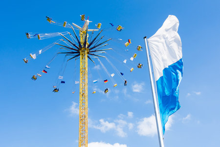 MUNICH, GERMANY - SEPTEMBER 30: People in a high chairoplane on the Oktoberfest in Munich, Germany on September 30, 2015. The Oktoberfest is the biggest beer festival of the world with over 6 million visitors each year. Foto taken from Theresienwiese.のeditorial素材