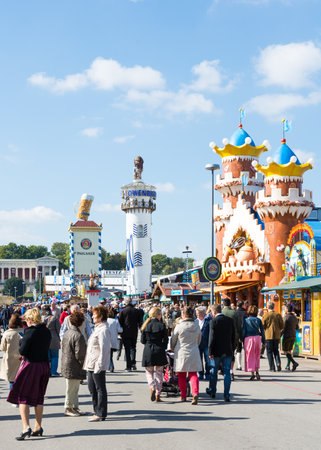 MUNICH, GERMANY - SEPTEMBER 30: People in front of the beer tents on the Oktoberfest in Munich, Germany on September 30, 2015. The Oktoberfest is the biggest beer festival of the world with over 6 million visitors each year. Foto taken from Theresienwieseのeditorial素材
