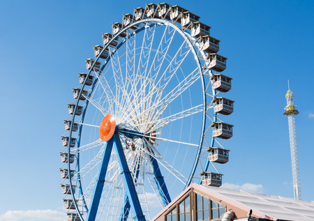 MUNICH, GERMANY - SEPTEMBER 30: Ferris wheel on the Oktoberfest in Munich, Germany on September 30, 2015. The Oktoberfest is the biggest beer festival of the world with over 6 million visitors each year. Foto taken from Theresienwiese.のeditorial素材