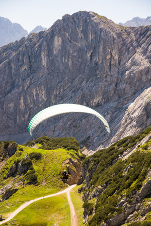 GARMISCH, GERMANY - JULY 10: Paraglider at the Osterfeldkopf mountain in Garmisch, Germany on July 10, 2016.のeditorial素材