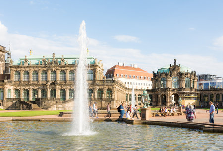 DRESDEN, GERMANY - AUGUST 22: Tourists at the Zwinger palace in Dresden, Germany on August 22, 2016. By 1963 the Zwinger had largely been restored after it was completely destroyed 1945. Foto taken from the public Zwinger park.のeditorial素材