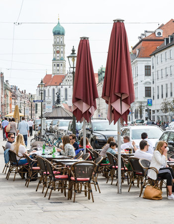 AUGSBURG, GERMANY - APRIL 1: People at a street  cafe in Augsburg, Germany on April 1, 2017. Augsburg is one of the oldest cities of Germany. Photo taken from Maximilianstrasse.のeditorial素材
