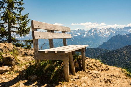 Empty wooden bench in the alps of Bavariaの写真素材